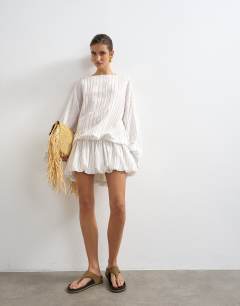 Model wearing Long sleeve blouson mini dress in white stripe