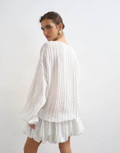 Model wearing Long sleeve blouson mini dress in white stripe