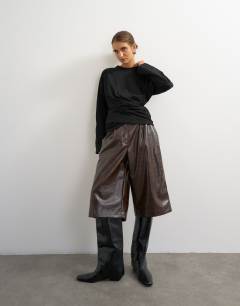 Model wearing Long sleeve draped detail top in black
