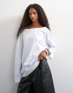 Model wearing Long sleeve fallen shoulder top in white