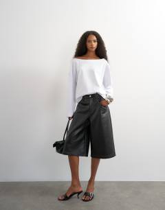 Model wearing Long sleeve fallen shoulder top in white