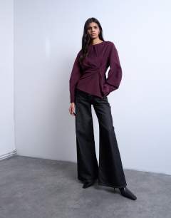 Model wearing Long sleeve pleat front top in burgundy