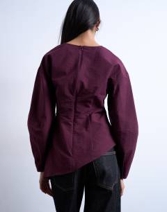 Model wearing Long sleeve pleat front top in burgundy