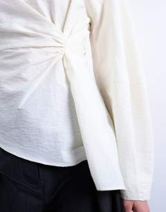 Model wearing Long sleeve pleat front top in ivory