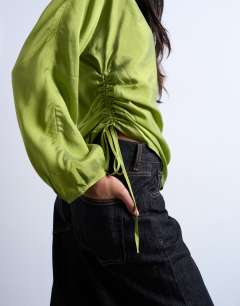 Model wearing Long sleeve ruched side top in green