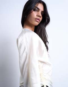 Model wearing Long sleeve ruched side top in white