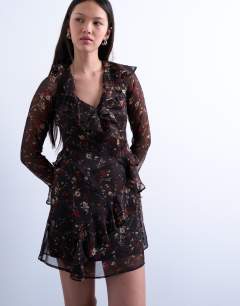 Model wearing Long sleeve ruffle mini dress in black base pink ditsy floral