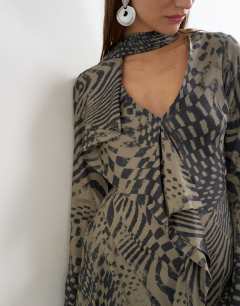 Model wearing Long sleeve ruffle mini dress with scarf wrap detail in abstract woodgrain print