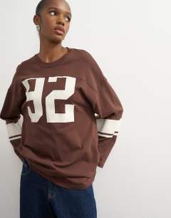 Model wearing Long sleeve skater '92' graphic t-shirt in chocolate