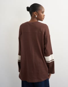 Model wearing Long sleeve skater '92' graphic t-shirt in chocolate