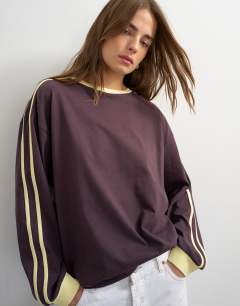 Model wearing Long sleeve skater stripe detail t-shirt in chocolate
