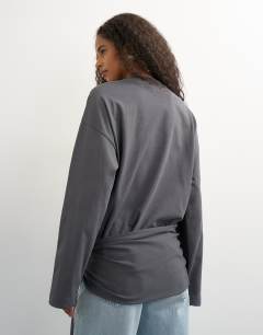 Model wearing Long sleeve tie waist detail top in charcoal