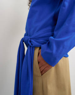Model wearing Long sleeve tie waist detail top in cobalt