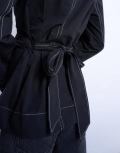 Model wearing Long sleeve tie waist top in black with contrast stitch