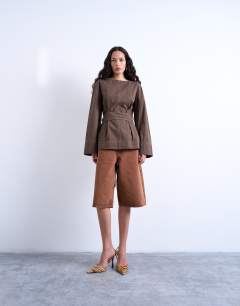 Model wearing Long sleeve tie waist top with contrast stich in brown