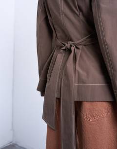 Model wearing Long sleeve tie waist top with contrast stich in brown