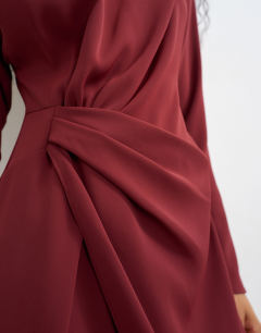 Model wearing Long sleeve tuck side mini dress in burgundy