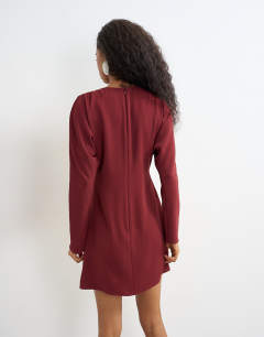 Model wearing Long sleeve tuck side mini dress in burgundy