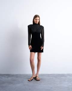 Model wearing Long sleeve velvet and chiffon mix mini dress with shoulder pads in black