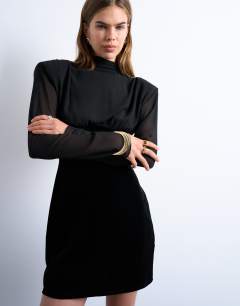 Model wearing Long sleeve velvet and chiffon mix mini dress with shoulder pads in black