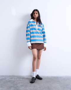 Model wearing Long sleeve woven polo top in blue stripe