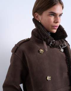 Model wearing Longline aviator shearling in chocolate