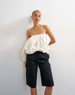 Model wearing Longline bermuda cargo short in black