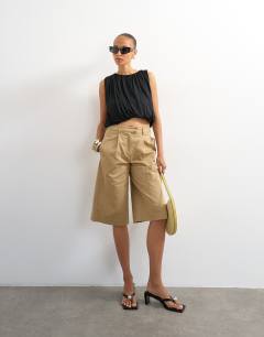 Model wearing Longline bermuda cargo short in ecru