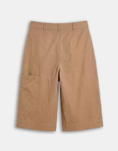Model wearing Longline bermuda cargo short in ecru