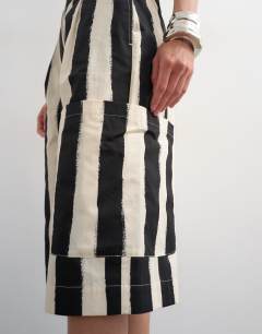 Model wearing Longline bermuda cargo short in mono stripe