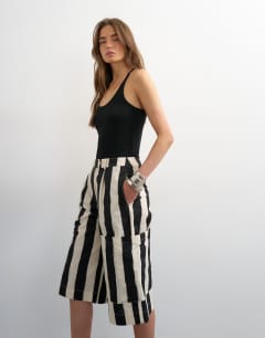 Model wearing Longline bermuda cargo short in mono stripe