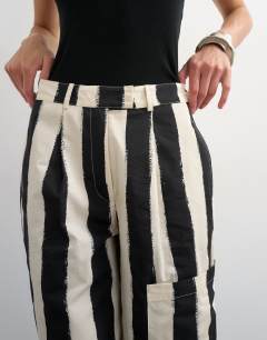 Model wearing Longline bermuda cargo short in mono stripe