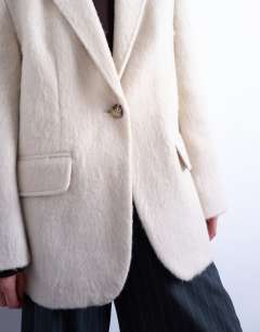 Model wearing Longline brushed one button blazer coat with wool in cream