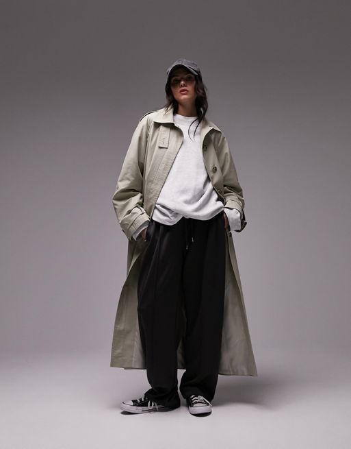 Topshop longline trench coat in light khaki. Notch collar, Button placket, Tie waist , Side pockets, Regular fit, maxi length. 
