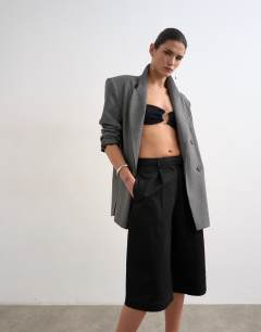 Model wearing Longline cargo short in black