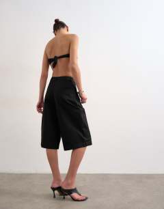 Model wearing Longline cargo short in black