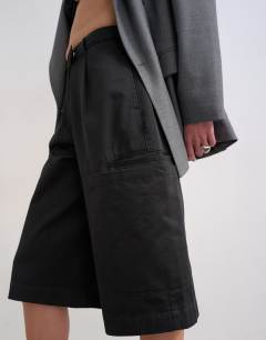 Model wearing Longline cargo short in black