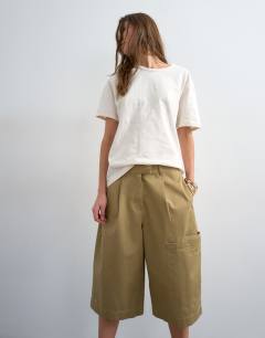 Model wearing Longline cargo short in tan