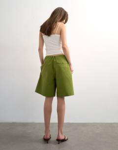 Model wearing Longline cargo short with bungee cords in green