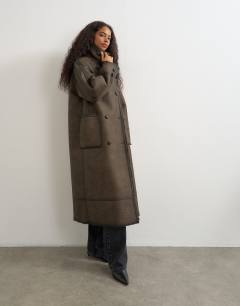 Model wearing Longline faux leather funnel neck coat in brown