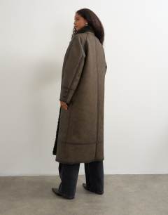 Model wearing Longline faux leather funnel neck coat in brown