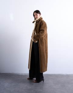 Model wearing Longline funnel aviator shearling in tan and cream