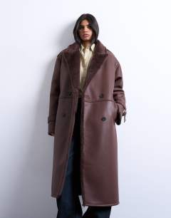 Model wearing Longline funnel oversized aviator borg coat in chocolate