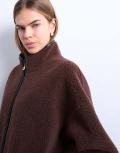 Model wearing Longline high neck chuck on shearling in chocolate