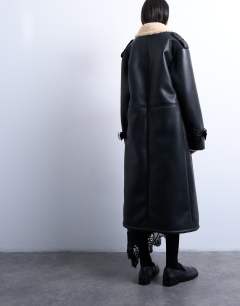 Model wearing Longline oversized aviator borg coat in black and cream