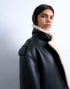 Model wearing Longline oversized funnel aviator borg coat in black and cream