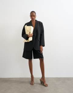Model wearing Longline tailored bermuda short in black