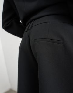 Model wearing Longline tailored bermuda short in black