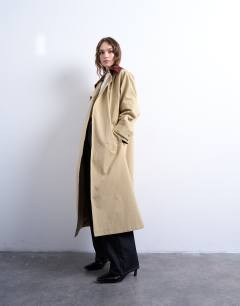 Model wearing Longline trench coat with contrast collar and buckle detail in beige