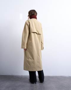 Model wearing Longline trench coat with contrast collar and buckle detail in beige